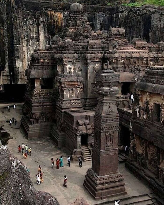 Massive ancient rock-cut temple carved from a mountain showing cool history facts.