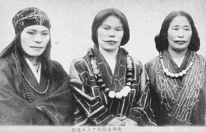 Three indigenous Ainu women with traditional mouth tattoos, showing surprising facts about the past.