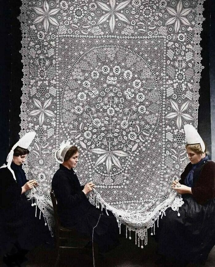 Three women creating intricate lace patterns, illustrating cool history and traditional craft.
