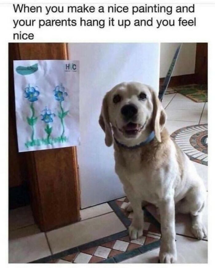 Sweet dog memes picture of a happy dog sitting next to a painted flower drawing hung on the wall.