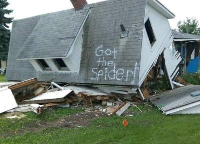 A completely collapsed house with Got the Spider written on the roof, a classic construction fail meme.