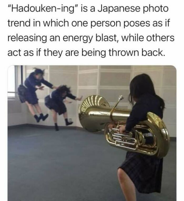 Wholesome memes picture of Japanese students doing a Hadouken-ing photo pose using a tuba.