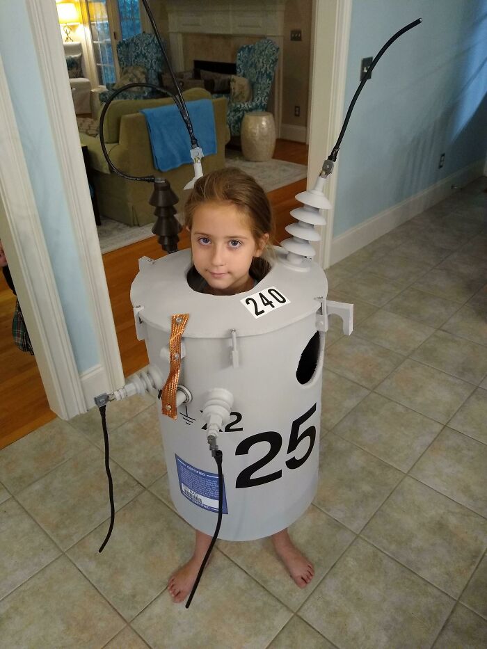 A girl wearing a homemade electrical transformer outfit for kids Halloween costumes.