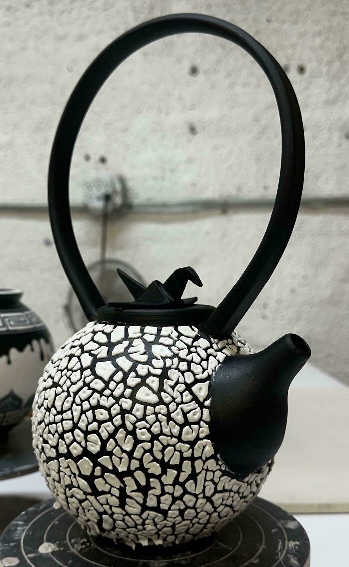A unique black and white textured teapot as part of creative pottery creations