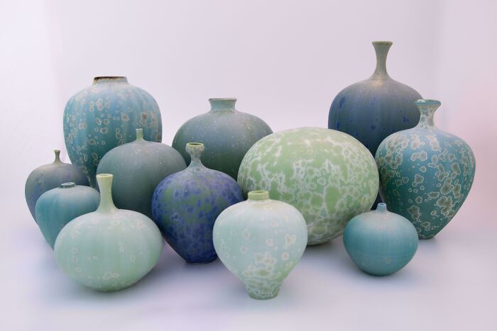 A collection of blue and green textured vases showcasing handmade pottery creations
