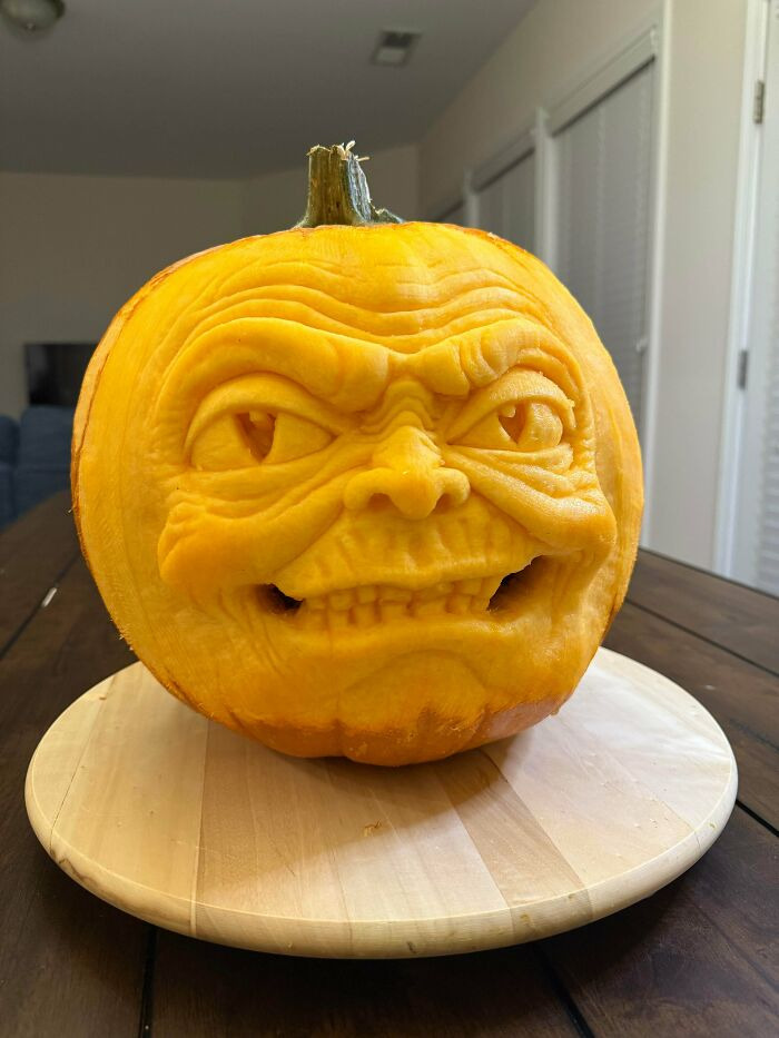 Detailed Halloween carved pumpkin with a spooky facial expression.
