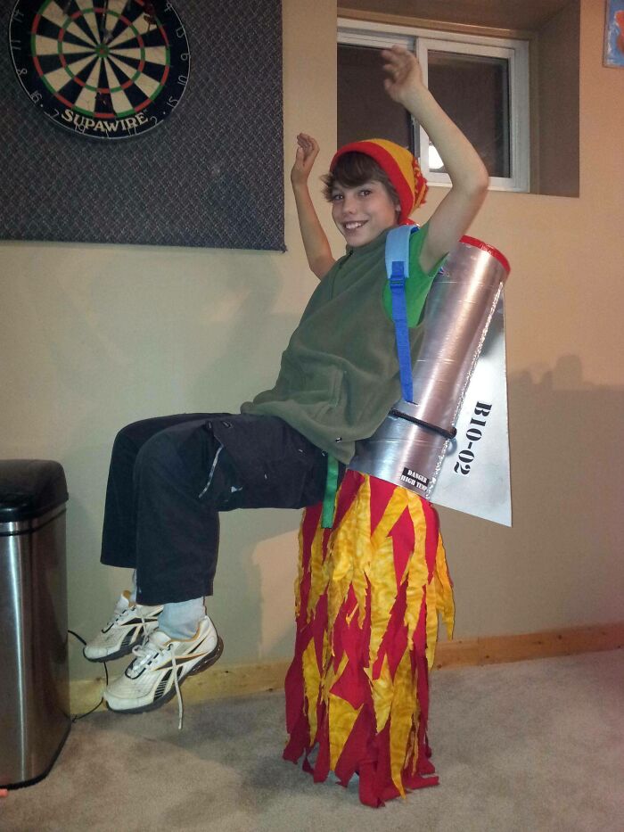 A boy wearing a homemade rocket jetpack optical illusion from creative kids Halloween costumes.