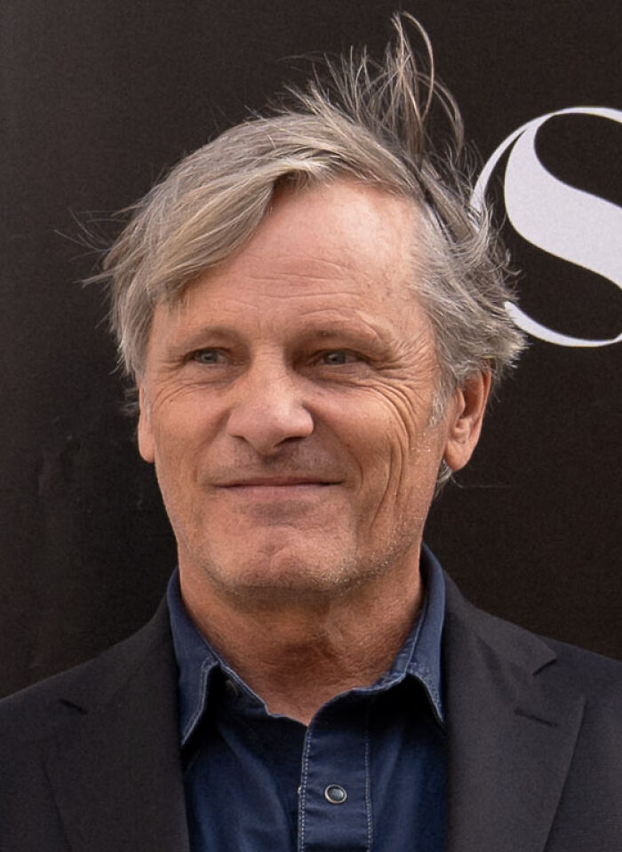 Actor Viggo Mortensen smiling in a black jacket during a career highlights event