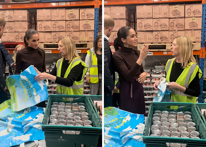 Meghan Markle during a food bank visit talking with a volunteer near shelves of food.