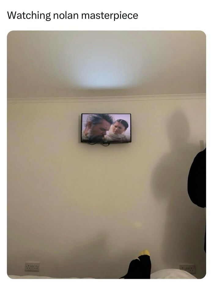 Relatable memes showing a tiny television screen mounted high on a large white wall displaying a movie scene.