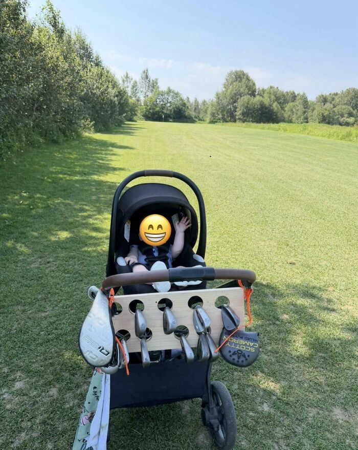 A baby in a stroller attached with golf clubs, highlighting wholesome pics of dads finding creative solutions.