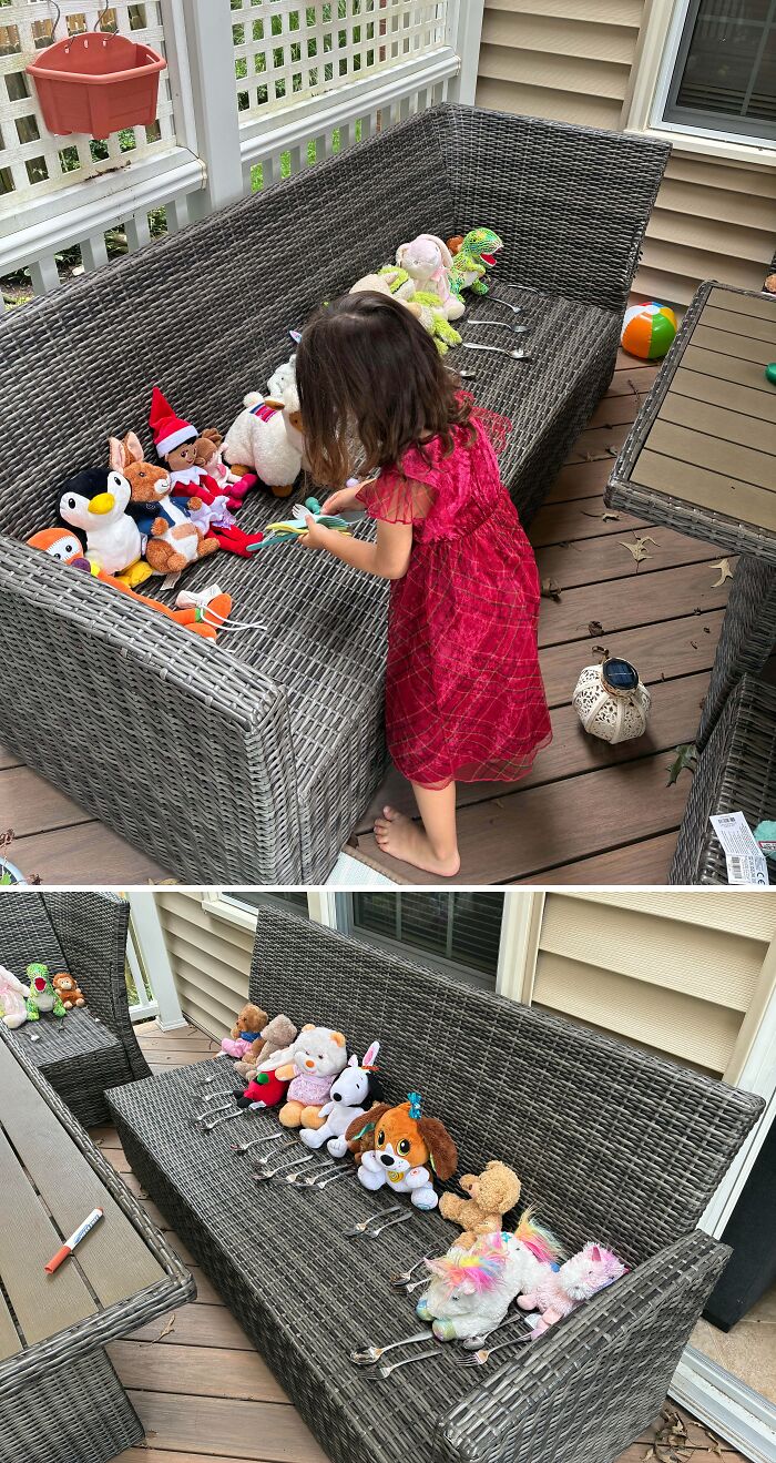 A young girl arranging stuffed animals on outdoor wicker couches for fatherhood wholesome pics.