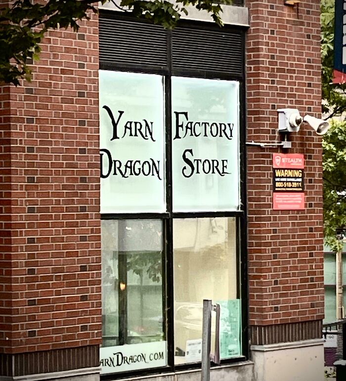 A storefront window with confusingly formatted text layout showcasing terribly designed signs.