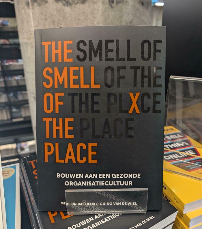 A terribly designed sign on a book cover featuring repetitive confusing text with the words smell and place