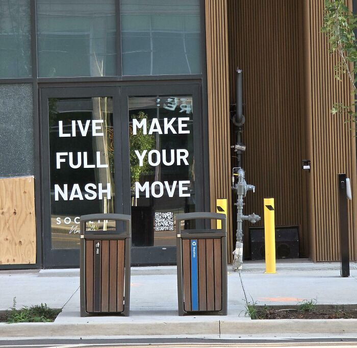 A terribly designed sign on glass doors with confusing layout reading Live Full Nash Make Your Move