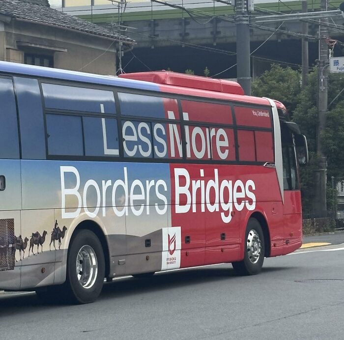 A red and blue bus with confusing text formatting showcasing terribly designed signs.