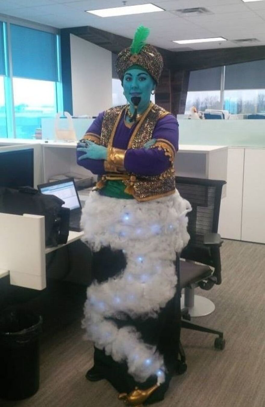 A person dressed in a Genie outfit with blue face paint, a creative Halloween costume idea for the office.