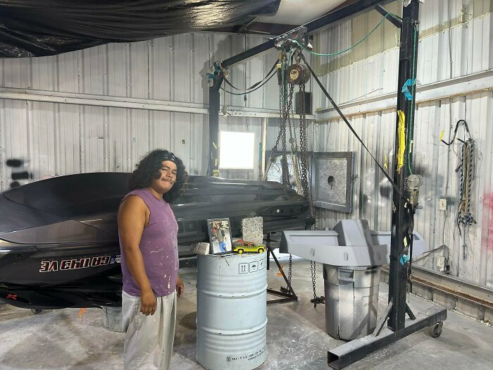 A father standing in his workshop in wholesome pics of dads celebrating working hard for their family
