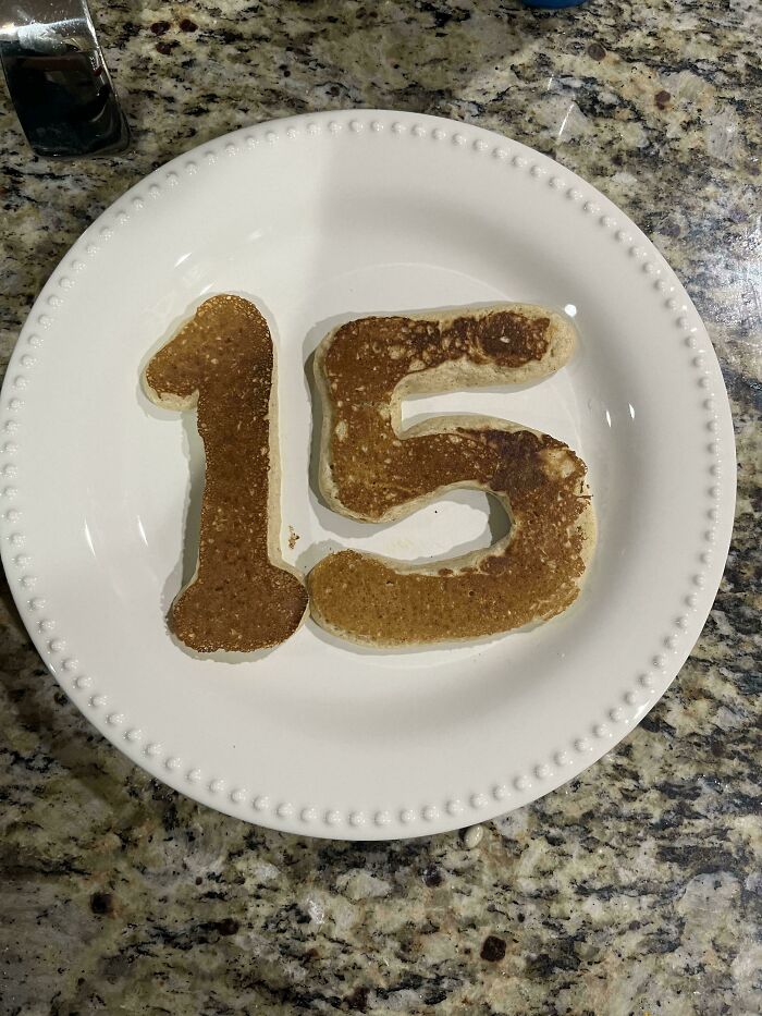 Pancakes shaped like the number 15 on a plate, representing wholesome pics of dads.