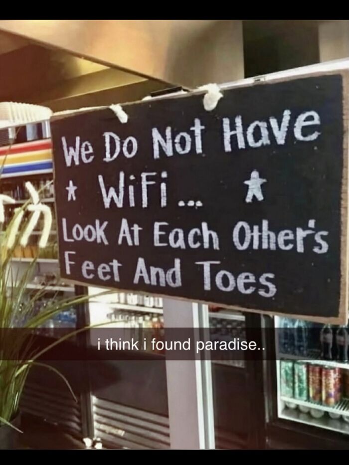 A hilarious meme showing a sign that says We Do Not Have WiFi Look At Each Other's Feet And Toes