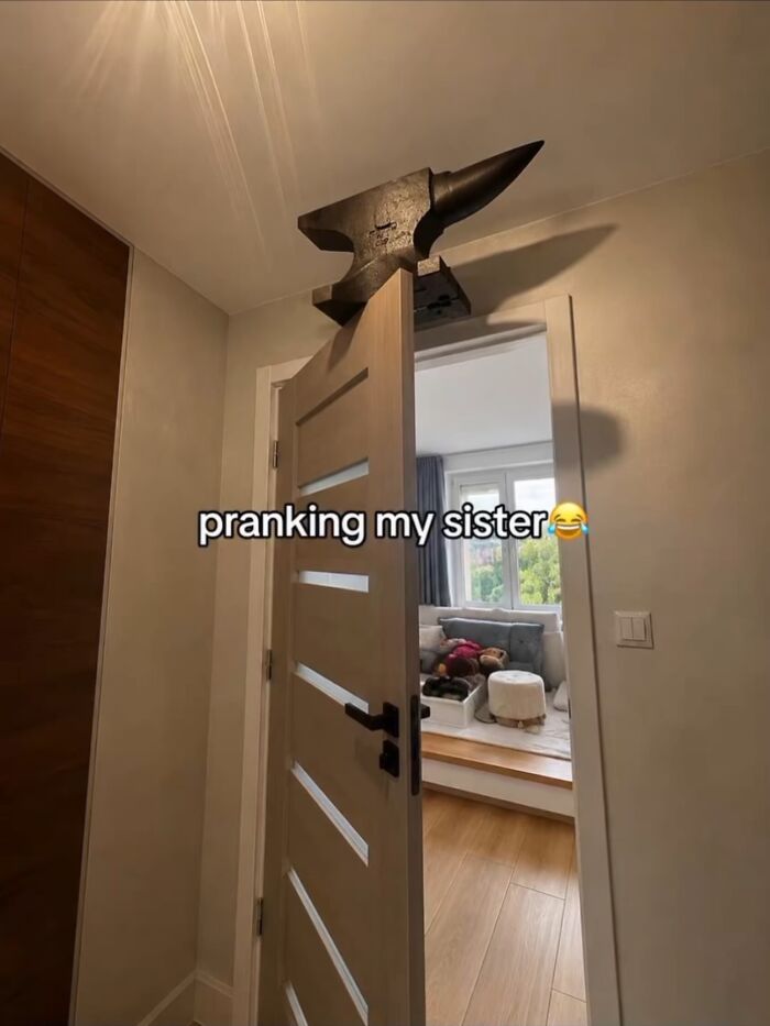 Dangerous prank setup with a heavy metal anvil balanced on an open door frame