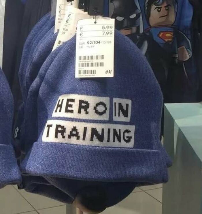 A blue beanie with misprinted text representing hilarious ads and signs
