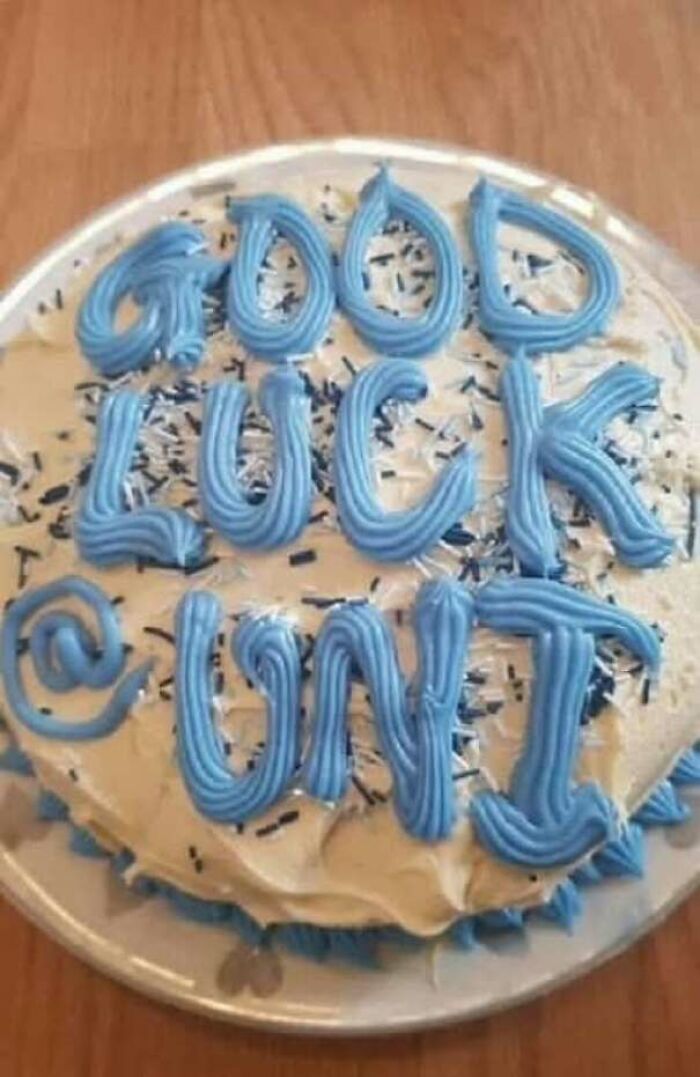 A cake decorated with blue icing that spells out an unfortunate phrase, representing a hilarious ad or message that missed the mark.
