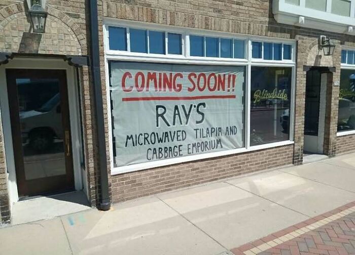 A storefront banner for Rays Microwaved Tilapia as a hilarious sign fail example