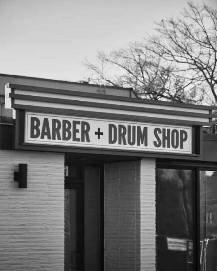 Storefront sign reading Barber + Drum Shop, featuring among unique ads and signs that missed the mark