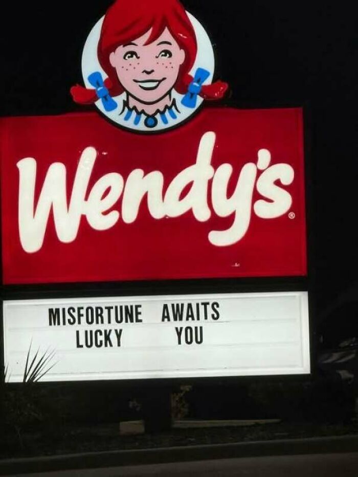 Hilarious signs: a Wendy's fast food sign with a confusingly arranged message reading Misfortune Awaits Lucky You.