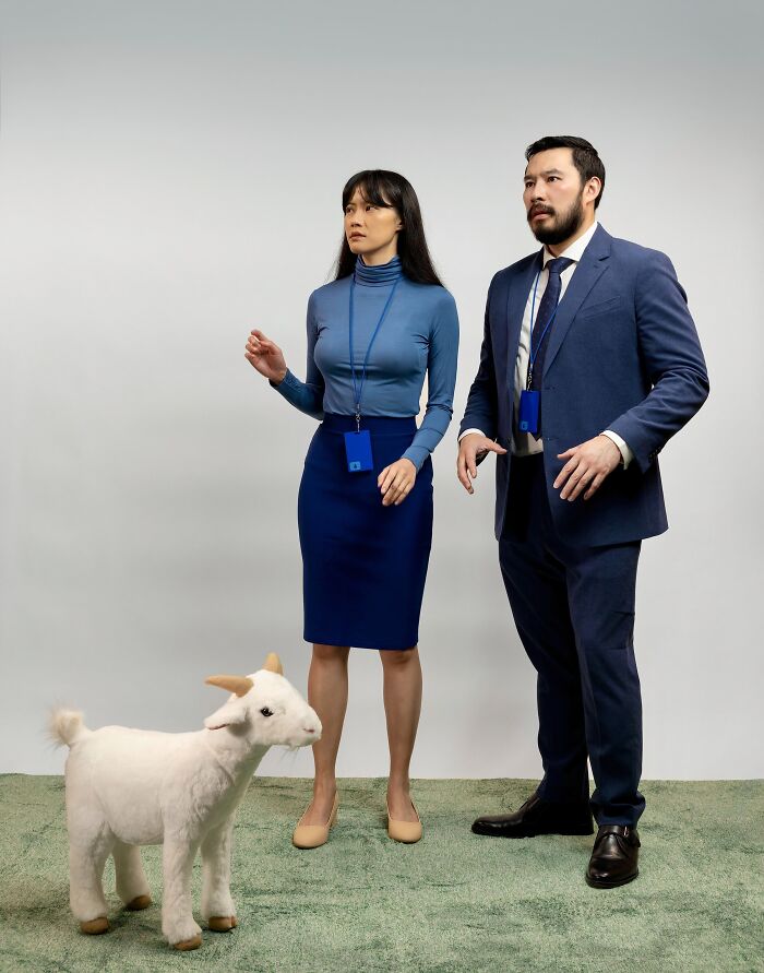 A man and woman dressed in office attire with a goat prop as funny cool Halloween couples costumes