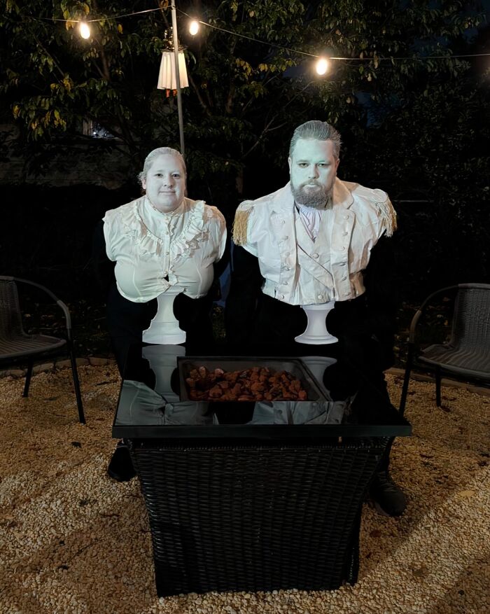 A couple dressed up as living marble busts for funny cool Halloween couples costumes