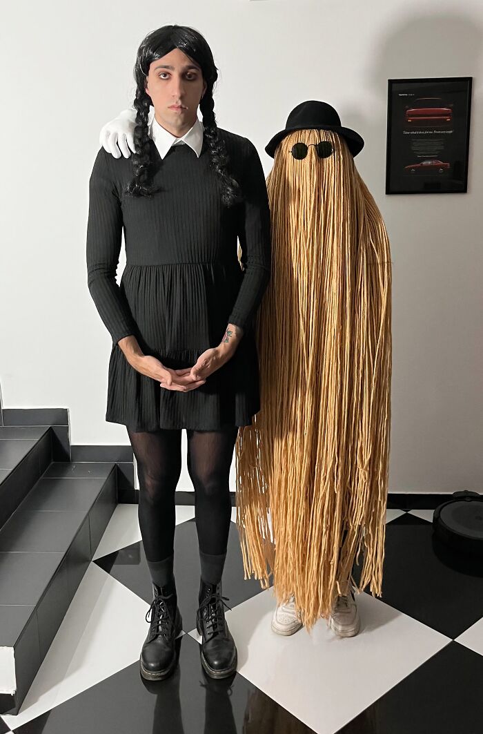 A couple dressed as Wednesday Addams and Cousin Itt in creative funny cool Halloween couples costumes