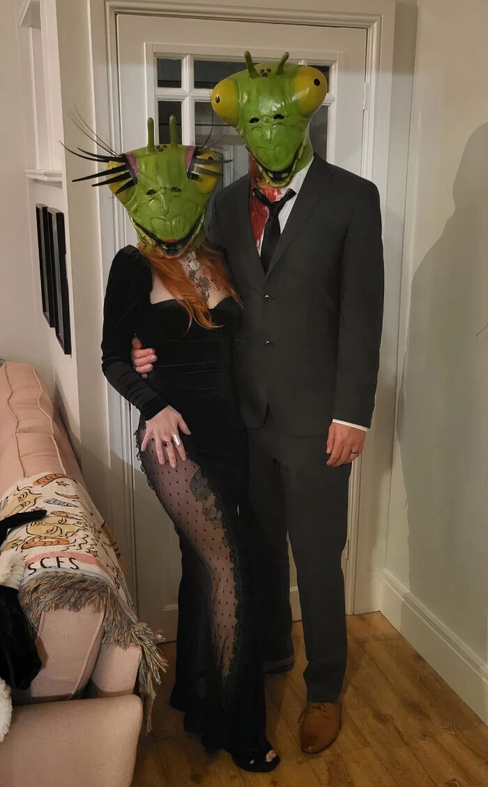 A couple wearing mantis masks and formalwear for creative funny cool Halloween couples costumes.