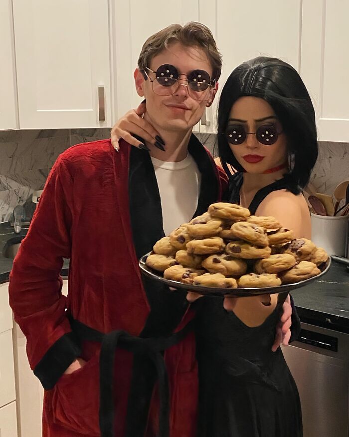 Couple in button-eye glasses holding cookies for funny Halloween couples costumes.