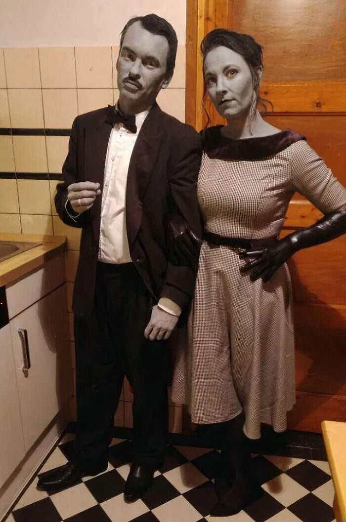 Black and white grayscale couple in vintage outfits standing together as funny cool Halloween couples costumes