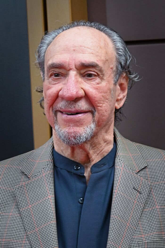 Actor F. Murray Abraham smiling in a patterned blazer at an event.
