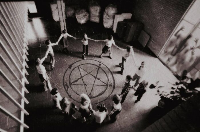 Children holding hands around a pentagram in creepy real-life photos resembling a horror movie scene