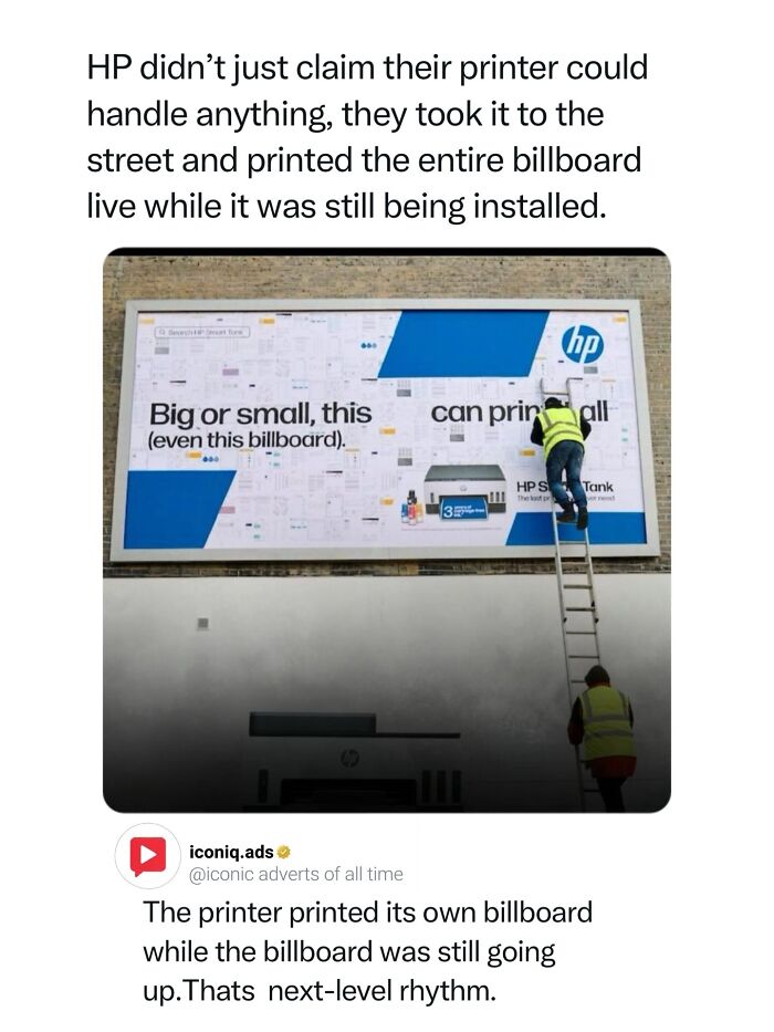Worker installing an HP printer billboard ad live, representing iconic ad concepts and guerilla marketing
