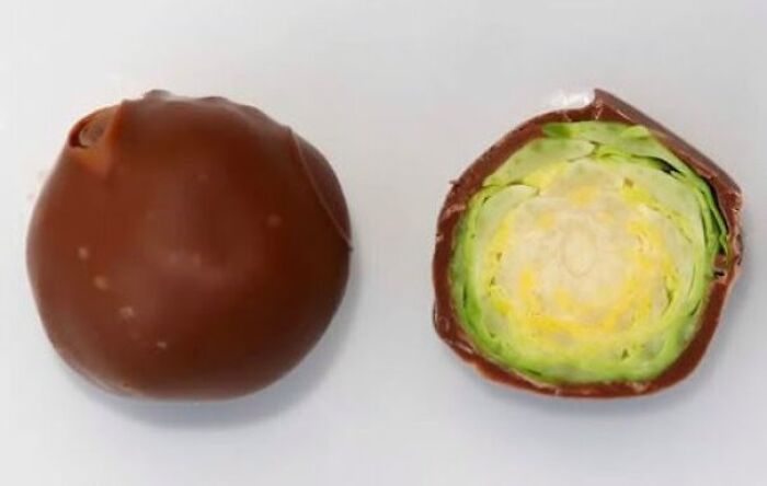 A chocolate truffle cut open to reveal a raw Brussels sprout inside for a funny Halloween joke