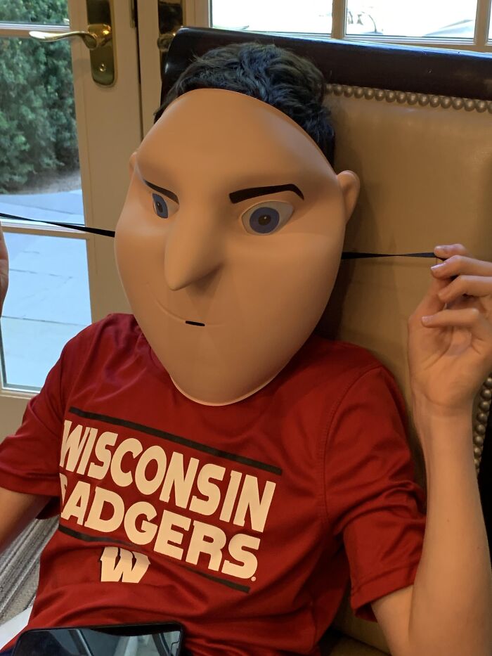 Person wearing a strange plastic Gru mask that fails to look like the character for Halloween