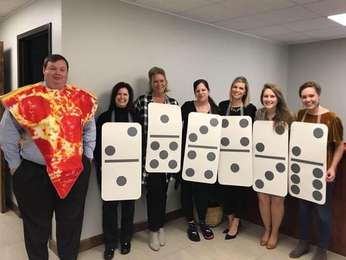 Funny Halloween photo of a group wearing Dominoes and pizza slice costumes in an office