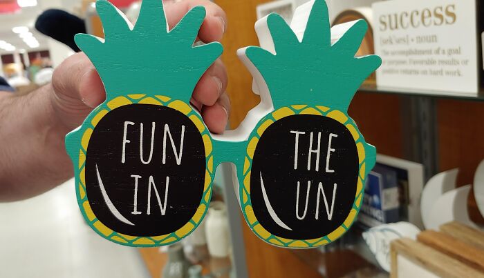 Green pineapple glasses displaying a hilarious spelling fail reading FUN IN THE UN.