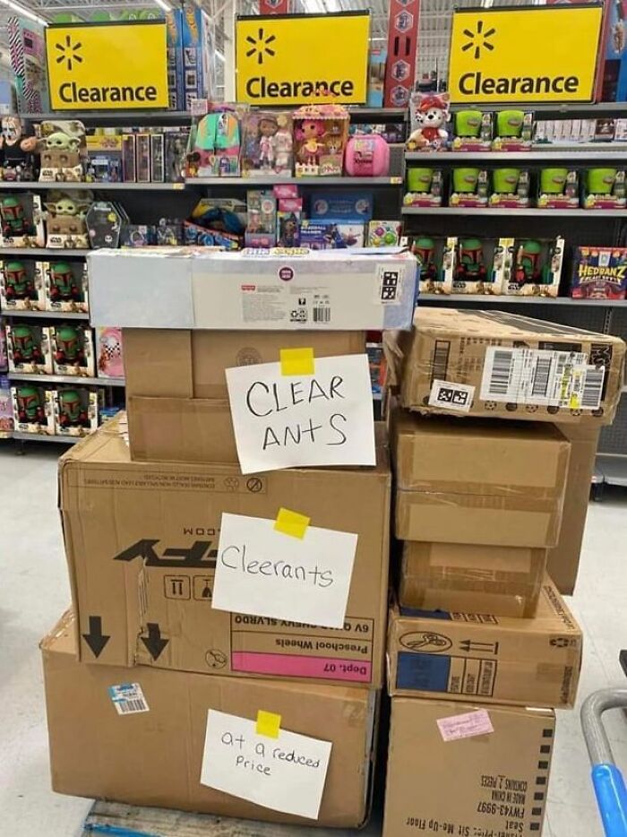 A funny spelling fail on a store sign reading CLEAR ANTS instead of clearance.