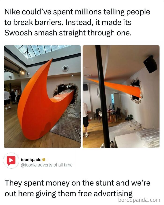 Large orange Nike swoosh crashing through a wall as an iconic and entertaining guerrilla ad.