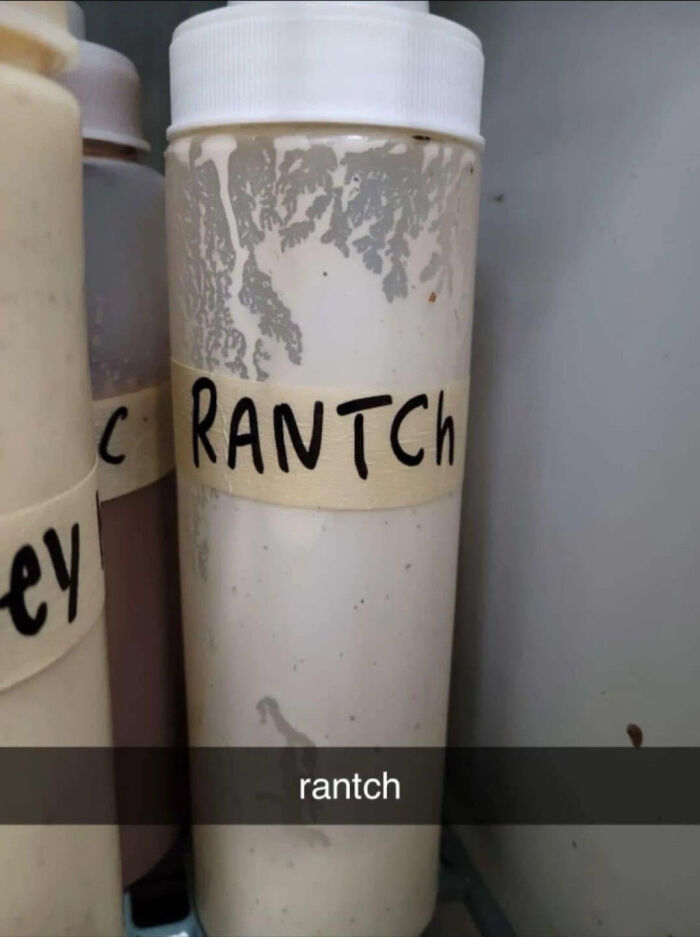 Plastic squeeze sauce bottle labeled with funny spelling fails writing RANTCH instead of ranch dressing