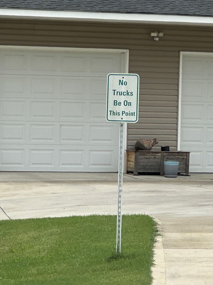 A sign outside reading No Trucks Be On This Point showing a spelling fail