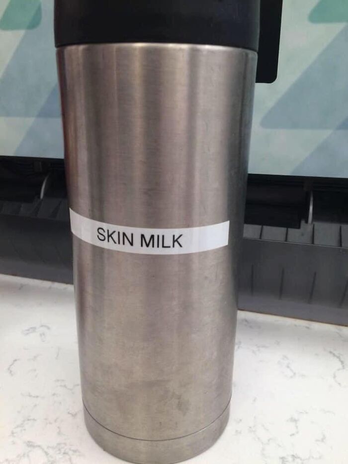 A stainless steel thermos flask marked SKIN MILK, illustrating funny spelling fails in everyday labeling.