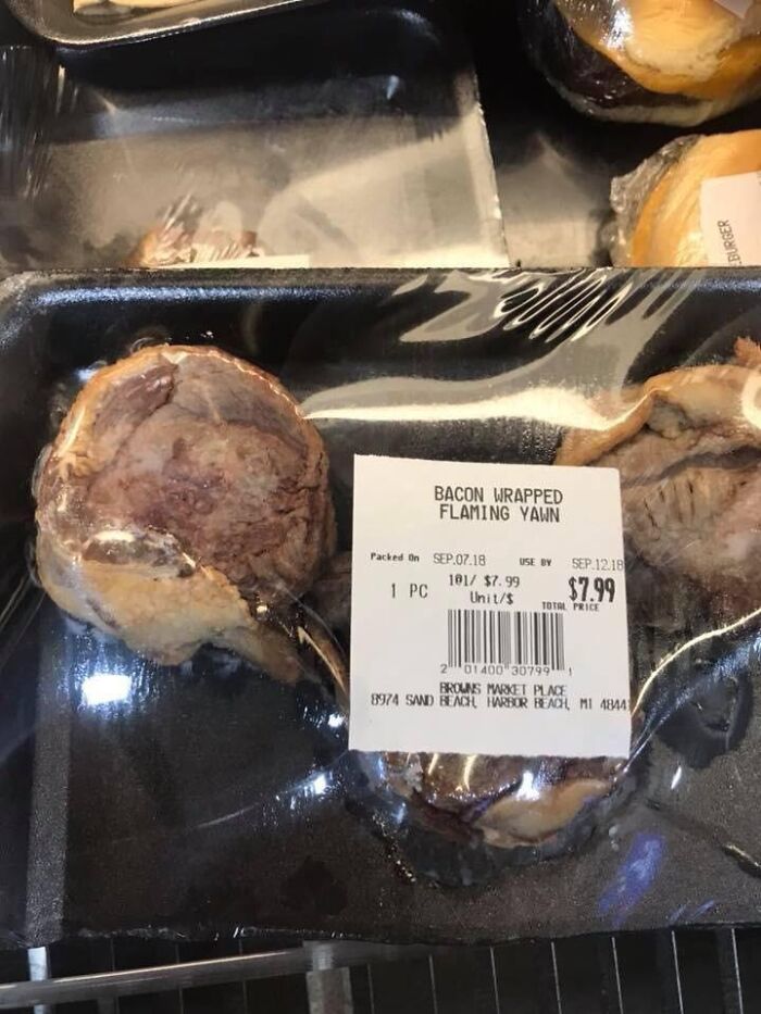 Packaged meat labeled BACON WRAPPED FLAMING YAWN, showing hilarious spelling fails on product labels.