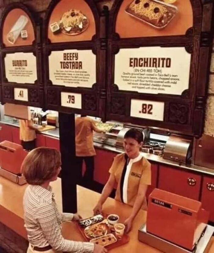Vintage photo showing a Taco Bell counter with menu options like Enchirito in classic America.